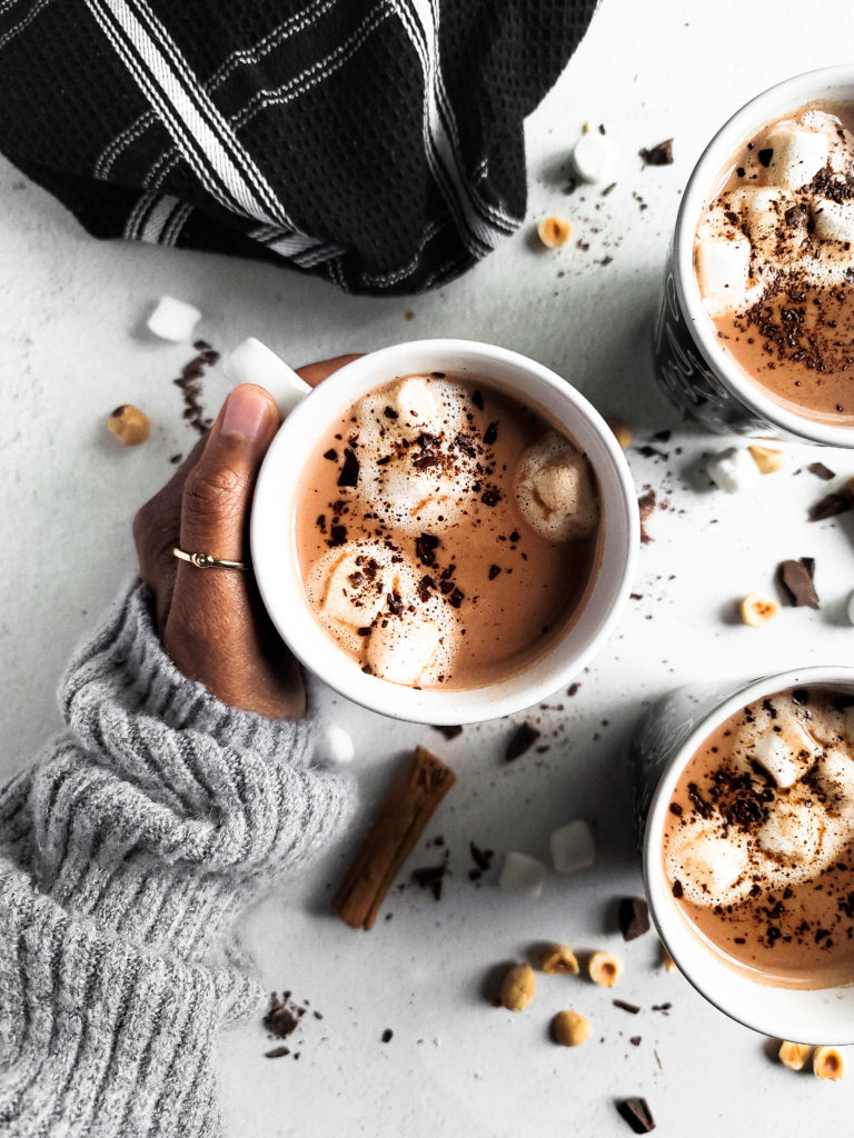 Overhead shot of 3 cups of hot cocoa with marshmallows